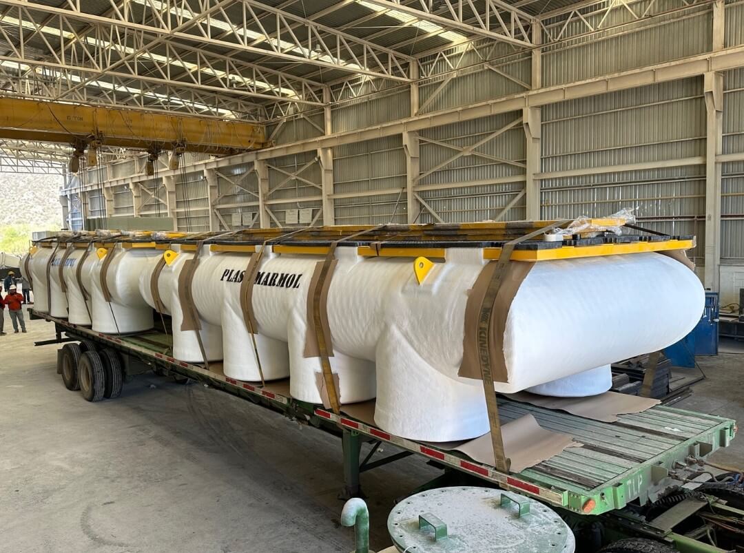FRP floating hulls strapped on a flatbed for shipment at the manufacturing facility