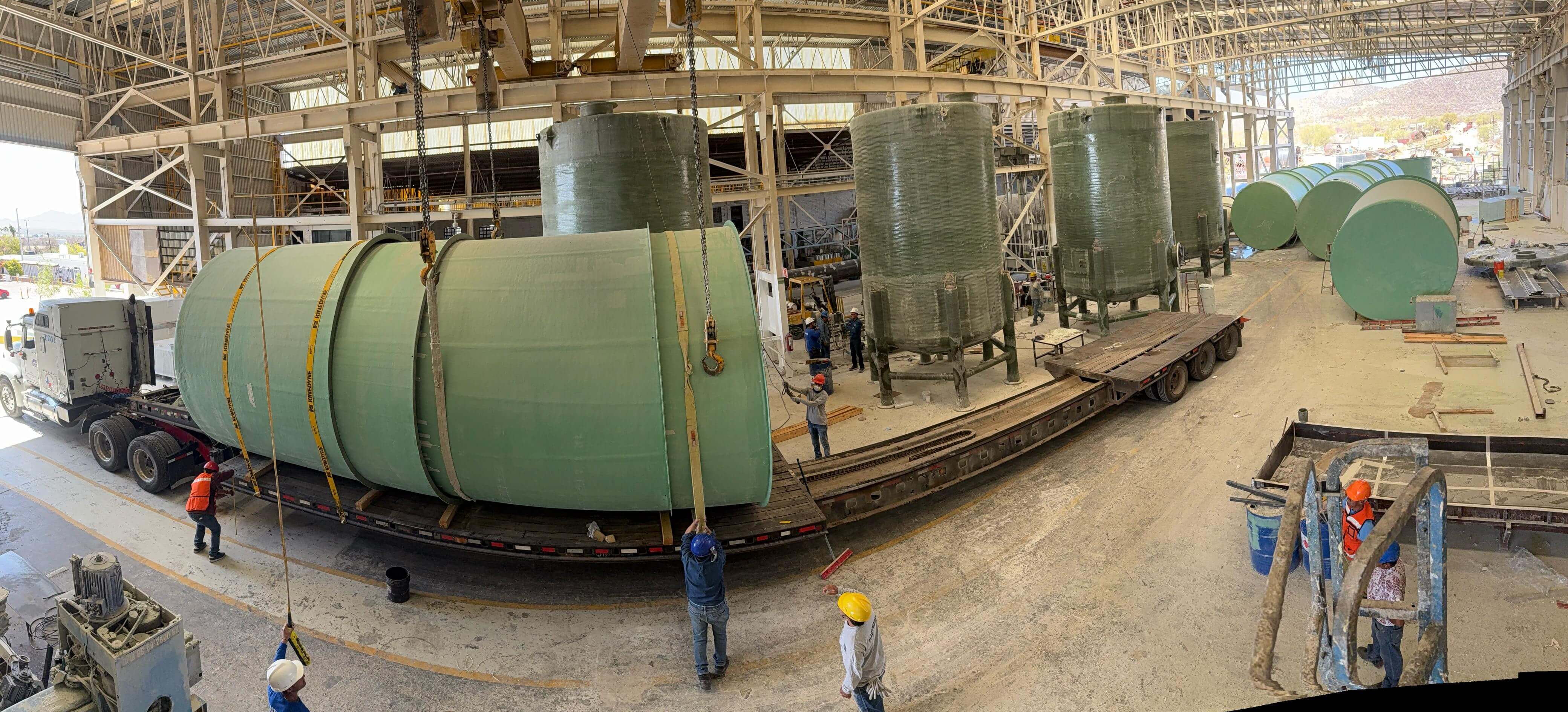 Engineer reviewing FRP tank technical specification at Plastimarmol manufacturing facility